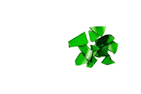 Sharp and jagged pieces of broken green glass cut out on a white background.. Stock Photos