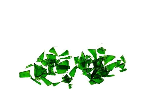 Sharp and jagged pieces of broken green glass cut out on a white background.. Stock Photos