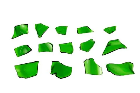 Sharp and jagged pieces of broken green glass cut out on a white background.. Stock Photos