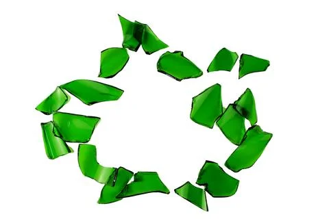 Sharp and jagged pieces of broken green glass cut out on a white background.. Stock Photos