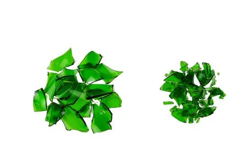 Sharp and jagged pieces of broken green glass cut out on a white background.. Stock Photos