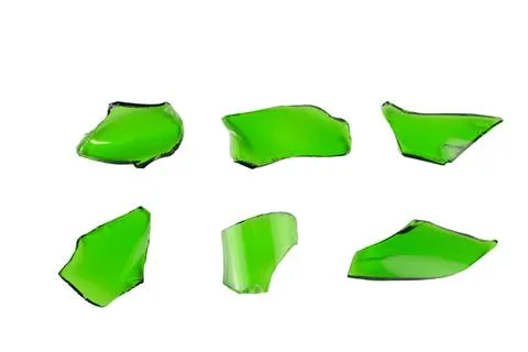 Sharp and jagged pieces of broken green glass cut out on a white background.. Stock Photos