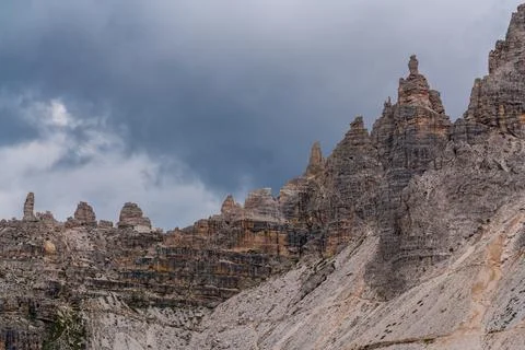 Sharp and towering rock peaks Dolomites rise dramatically against sky, showca Stock Photos