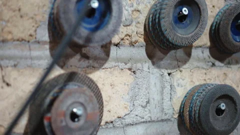 Sharp angle grinder wheels of different sizes hanging on the wall in workshop Stock-Footage 266170629