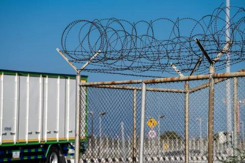 Sharp barbed wire border fence blocking access. Surveillance, conflict, and.. 库存照片
