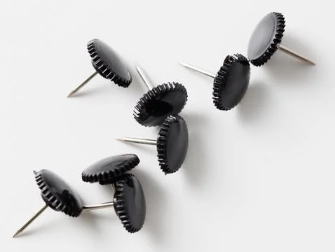 Sharp black button rivets on white background Stock Photos