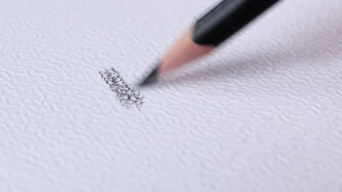 A sharp Black pencil draws on white textural paper, capturing the essence Stock Footage 287565918