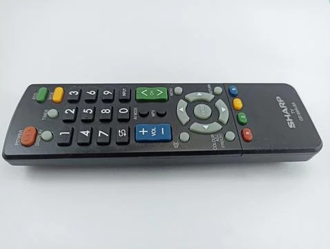 A sharp black TV remote control with a white background Stock Photos