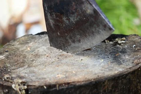 A sharp blade of an ax that sticks out in a wooden chock. rustic concept. Free Stock Photos