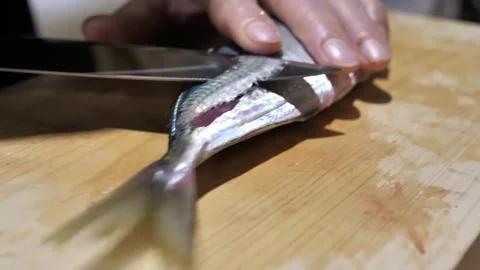 Sharp Blade Filleting a Silver Fish Along the Bone Stock Footage 340900796