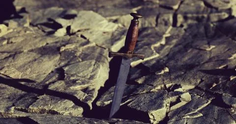 Sharp blade stands strong amidst rugged rocks and terrain Stock Illustration
