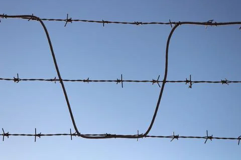 Sharp Boundaries: Spiked Metal Wire Stock Photos