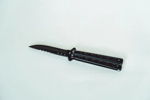 Sharp butterfly knife in various positions on a white background Foto stock