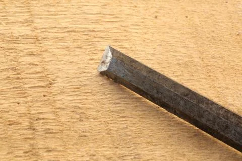 Sharp chisel on rough wooden background Stock Photos