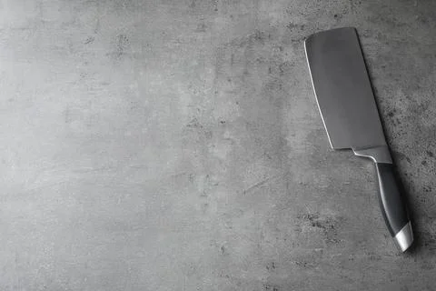 Sharp cleaver and space for text on grey background, top view 库存照片