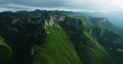Sharp Cliffs Green Humid Rainforest Dark Cloudy Sky Aerial Rise Cinematic Stock Footage 289411907
