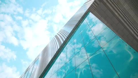 Sharp corner of turquoise glass facade and metal roo Stock Footage 326003041