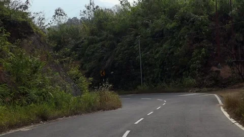 Sharp Curve on Forested Mountain Road Stock Footage 329840442