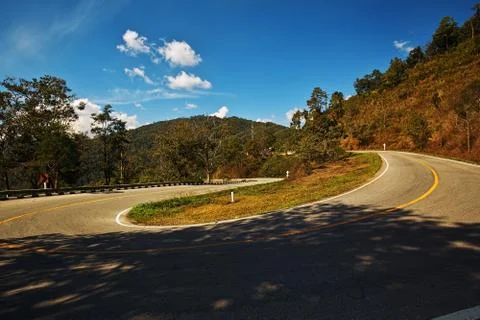 Sharp curve on a mountain road Stock Photos