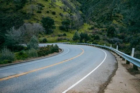 Sharp curve on a rural mountain road through the California foothills Stock Photos