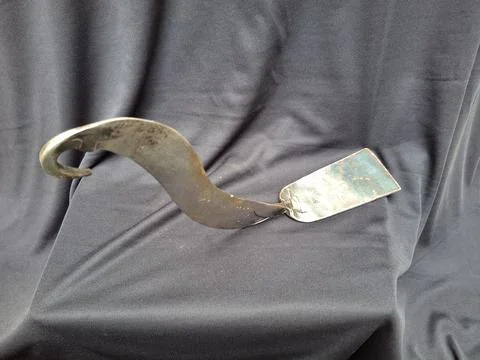 Sharp, curved sickle with sturdy handle, ideal for harvesting crops Stock Photos