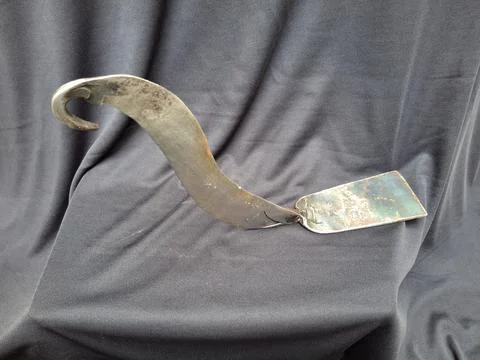 Sharp, curved sickle with sturdy handle, ideal for harvesting crops Stock Photos
