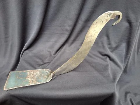 Sharp, curved sickle with sturdy handle, ideal for harvesting crops Stock Photos