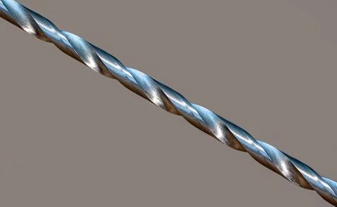 Sharp cuts of screw-threads on a metal drill, macro view. Stock Photos