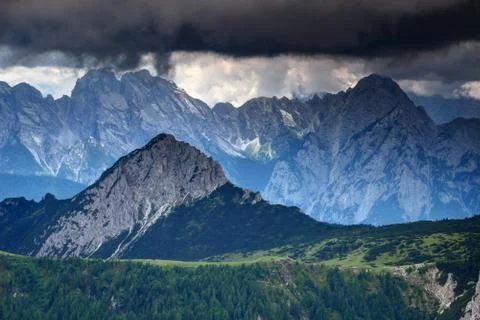 Sharp edged peaks under threatening dark clouds in Carnic Alps Stock Photos
