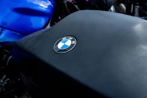 Sharp focus on a motorcycle with an iconic emblem parked among other bikes in an Stock Photos