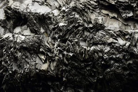 Sharp fragmented textures of heavily weathered volcanic rock face in Iceland Stock Photos