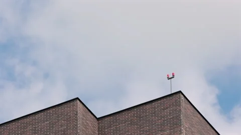 The Sharp Geometric Corner Of A Modern Dark Brick Building Against A Bright Blue Video stock 322583344
