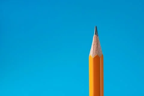 Sharp graphite pencil on light blue background, closeup. Space for text Stock Photos