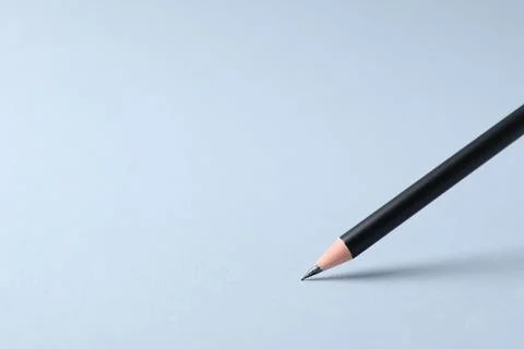 Sharp graphite pencil on light grey background, closeup. Space for text 스톡 사진