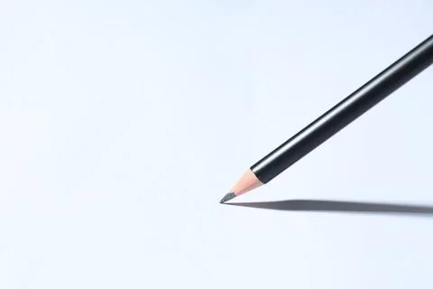 Sharp graphite pencil on white background, closeup. Space for text Stock Photos