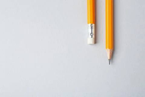 Sharp graphite pencils on grey background, top view. Space for text Stock Photos