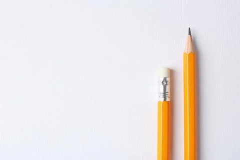 Sharp graphite pencils on light background, top view. Space for text Stock Photos