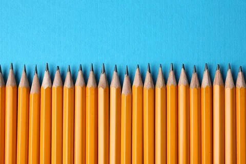 Sharp graphite pencils on light blue background, flat lay. Space for text Foto stock