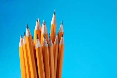 Sharp graphite pencils on light blue background, closeup. Space for text Stock Photos