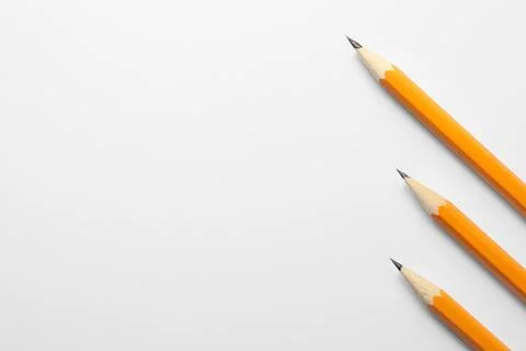 Sharp graphite pencils on white background, flat lay. Space for text Foto stock