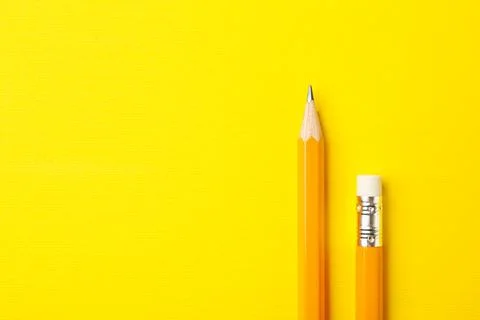 Sharp graphite pencils on yellow background, top view. Space for text Stock Photos