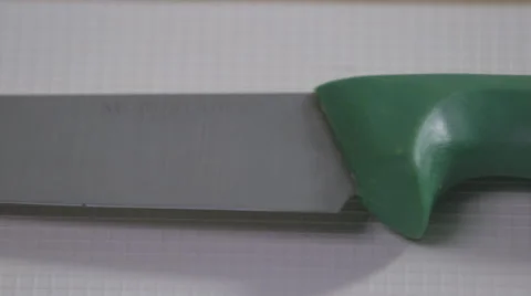 Sharp green handle veg Knife on a white surface pan Stock Footage 64028422