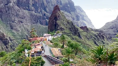 A sharp high cliff rises in the middle of a mountain valley. Spain. Stock Footage 276192421