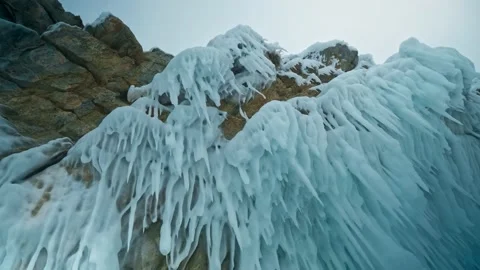 Sharp ice spikes dangling from rocks. Icicles over my head. Lake Baikal, Siberia Stock Footage 228883330