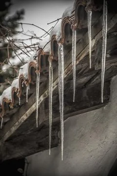Sharp icicles on a rooftop Foto stock