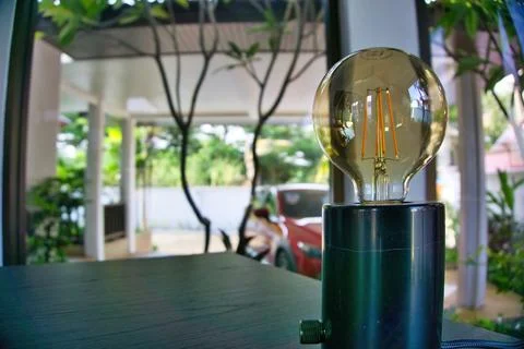 Sharp Image of Lightbulb in Freestanding Fixture on Table 스톡 사진
