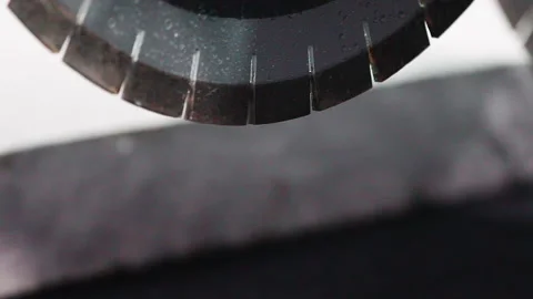 The sharp industrial saw is getting ready for sawing through the granite block Stock Footage 237519523