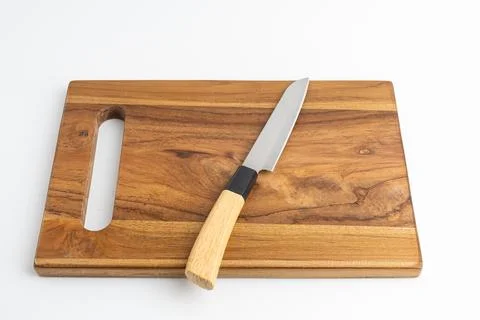 Sharp kitchen chef knife resting on wooden cutting board isolated on white .. Stock Photos