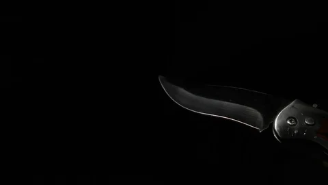 A sharp knife with a beautiful blade in his hand. Stock Footage 122287410
