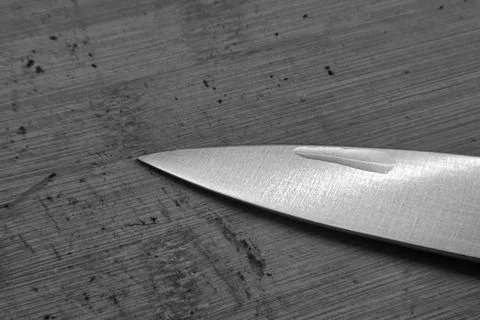 Sharp Knife Blade on Wooden Surface - Precision and Craftsmanship in Kitche.. Stock Photos